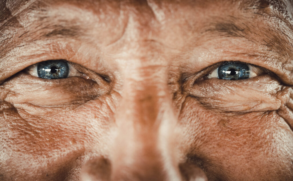 Close up of senior man's blue eyes looking at camera.